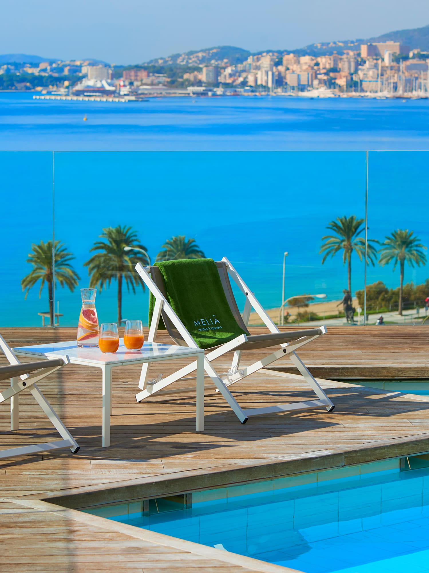 chairs on a deck near a pool
