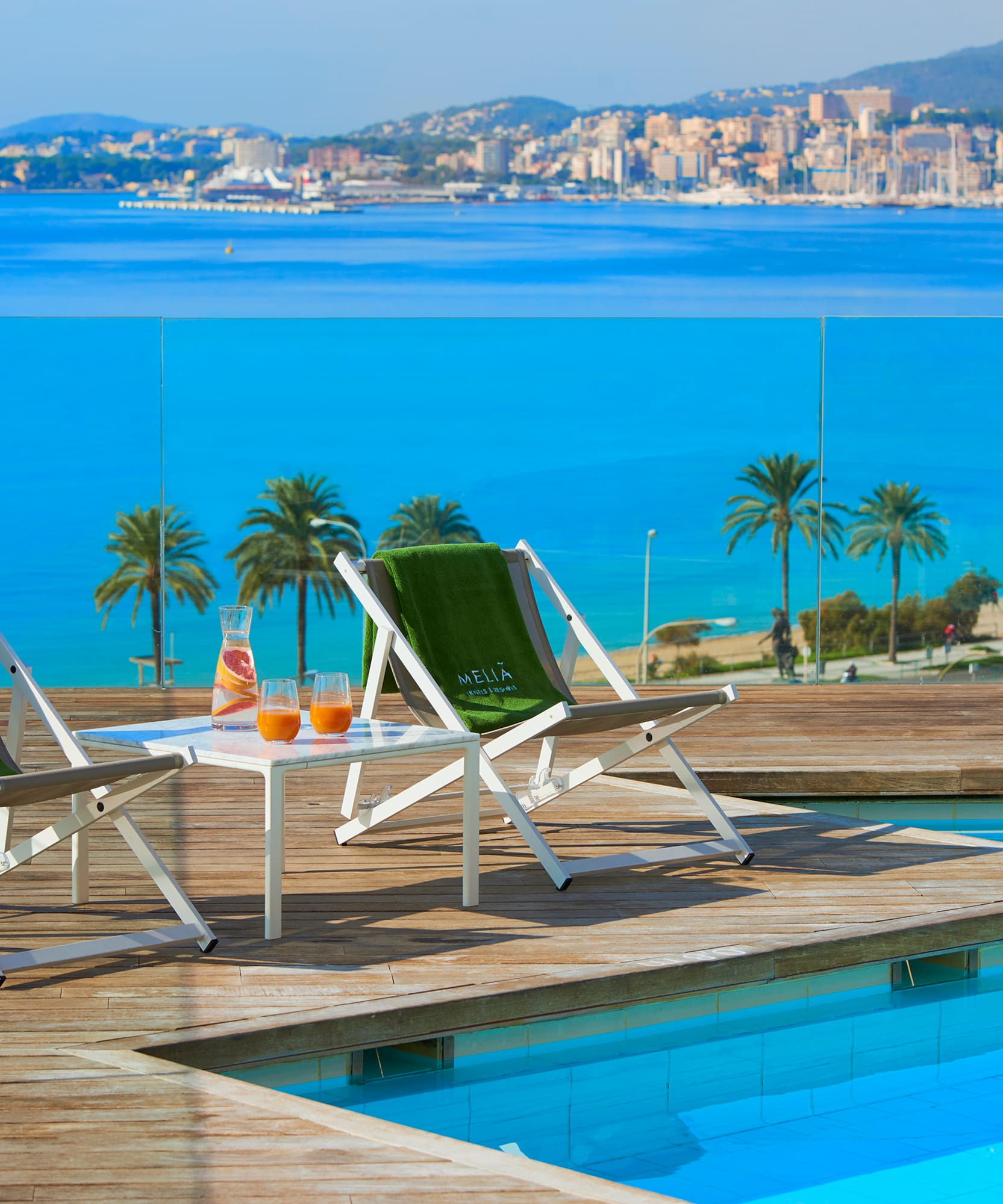 chairs on a deck near a pool
