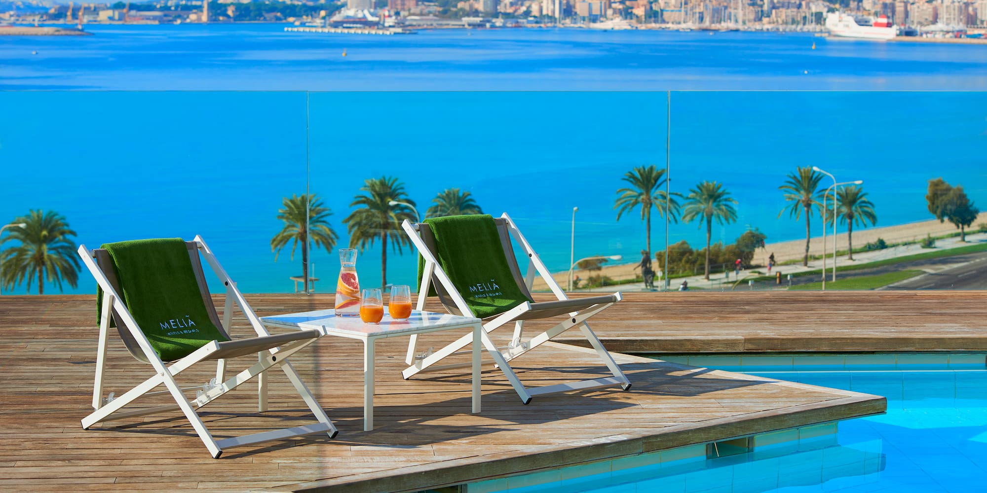 chairs on a deck near a pool