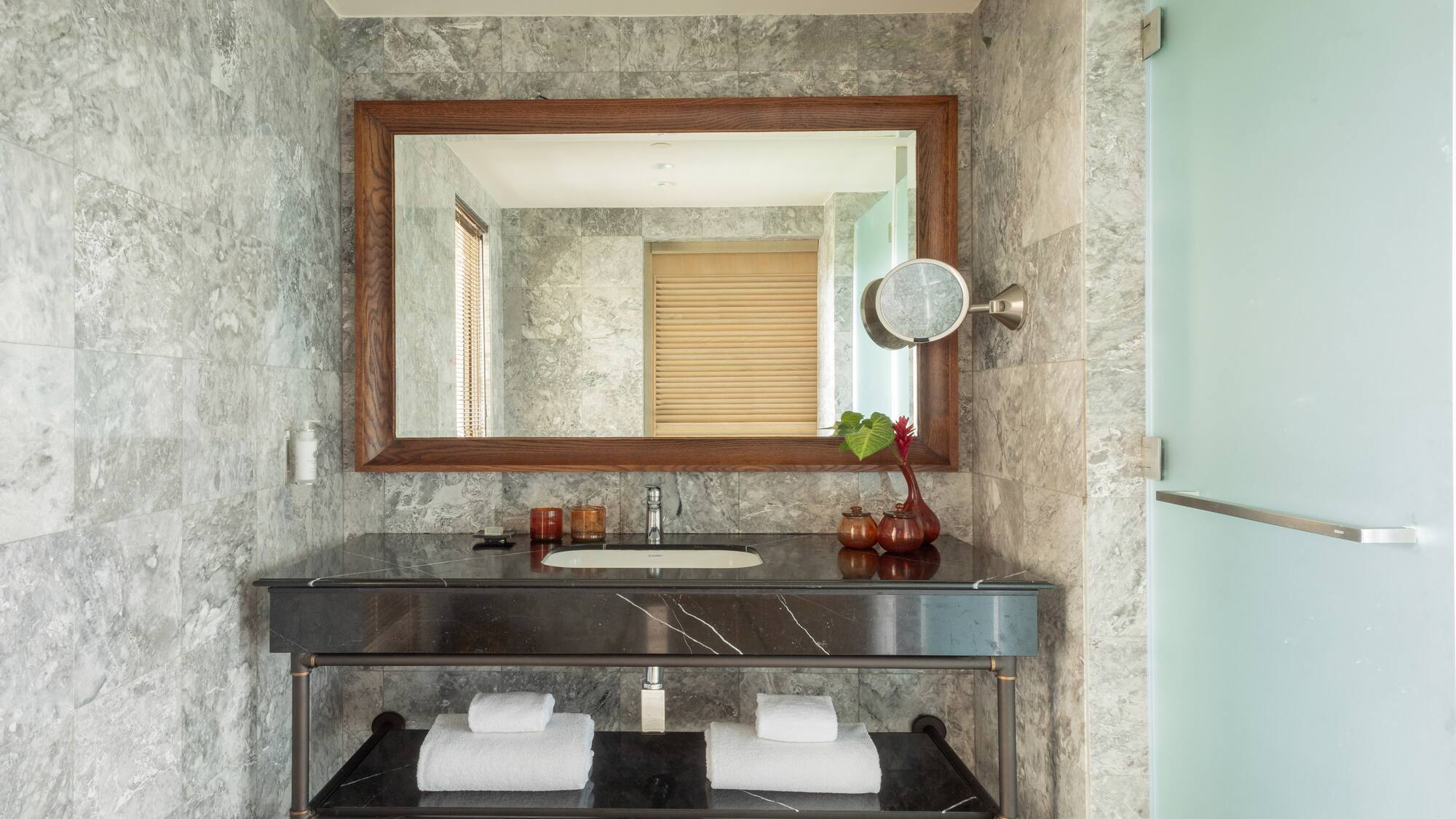 a bathroom with a marble countertop and a mirror