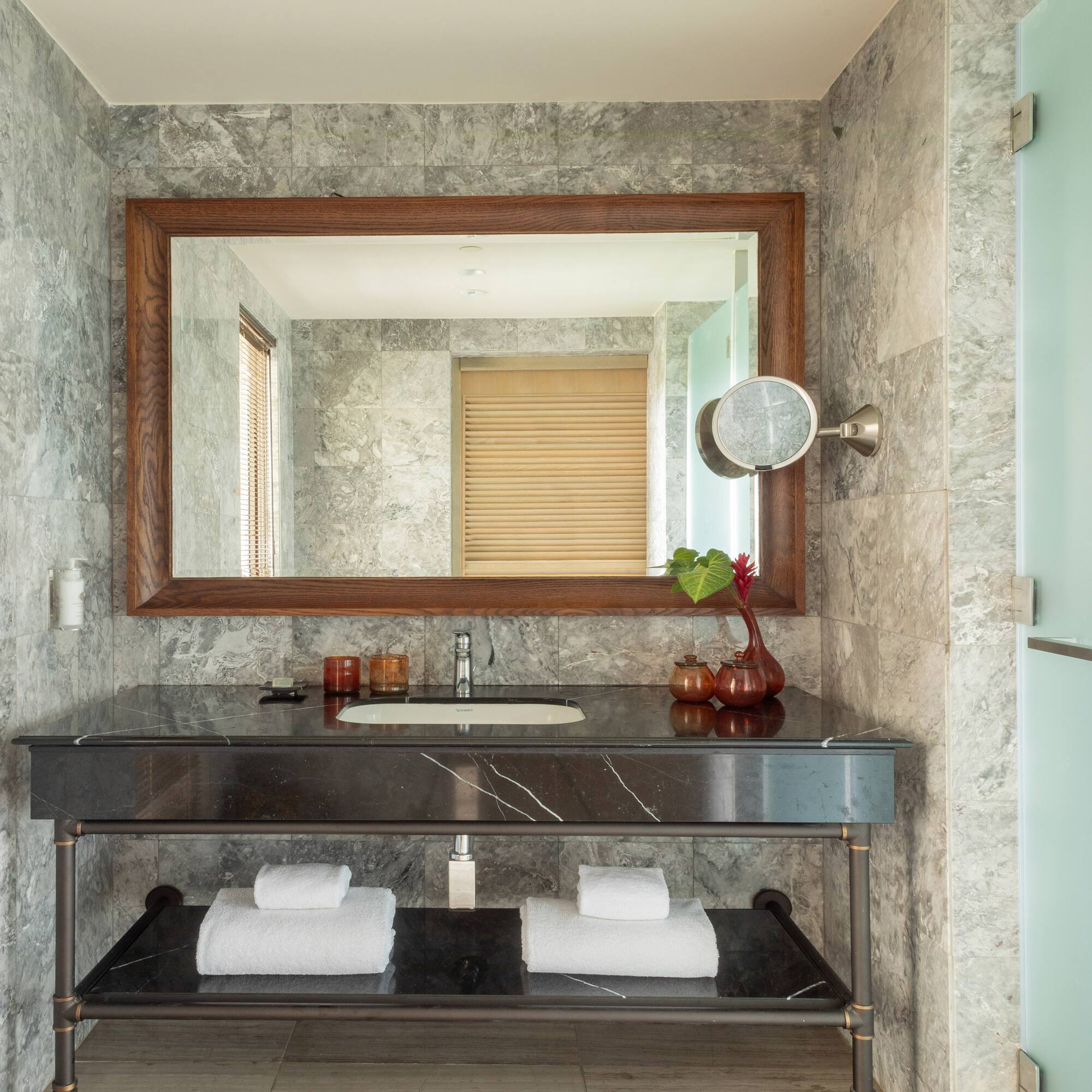 a bathroom with a marble countertop and a mirror