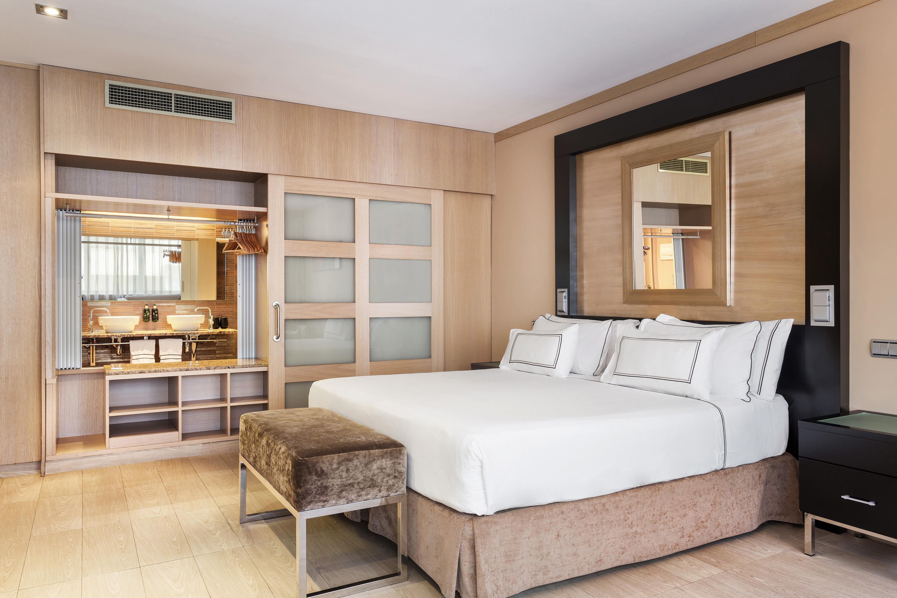 a bedroom with a bed and a mirror