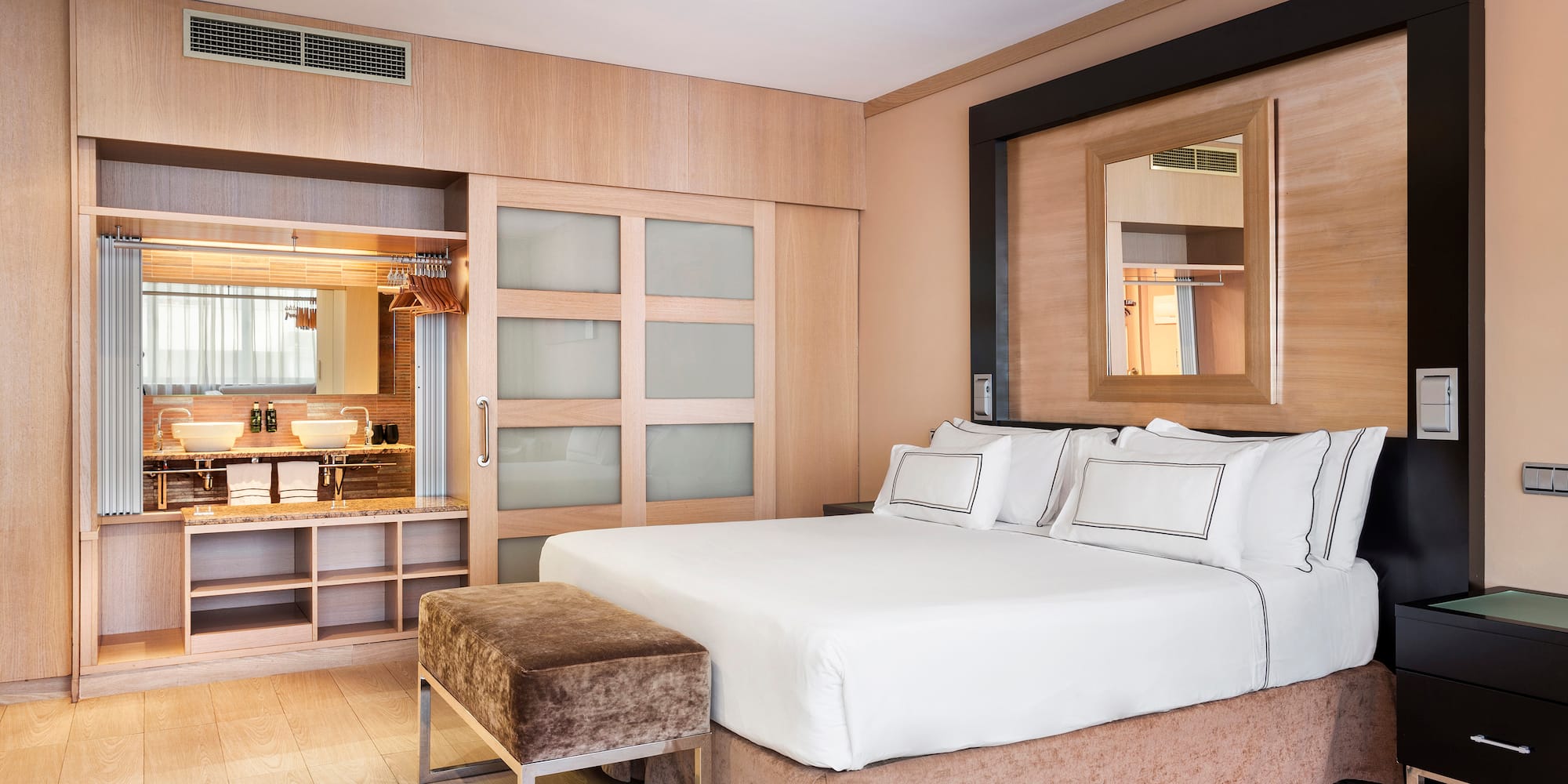 a bedroom with a bed and a mirror