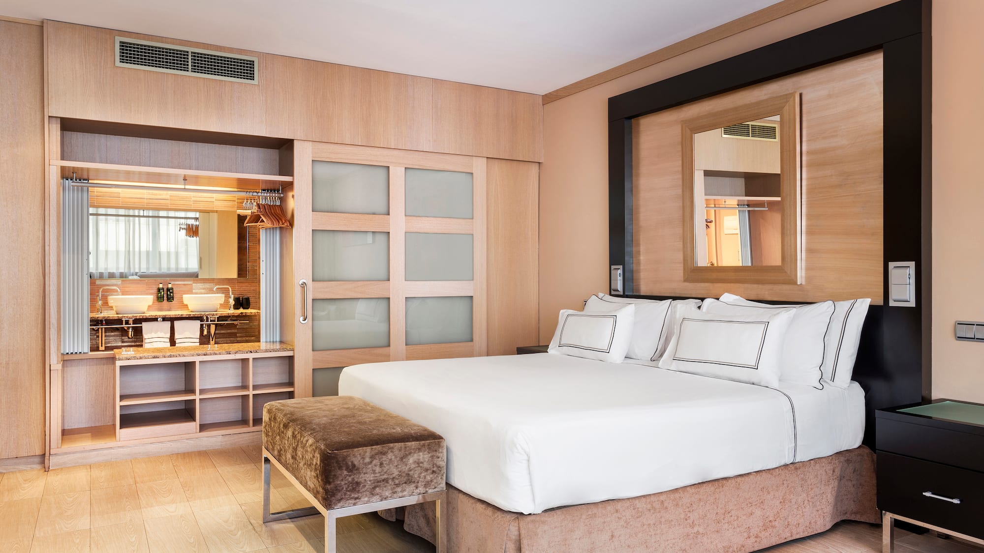 a bedroom with a bed and a mirror