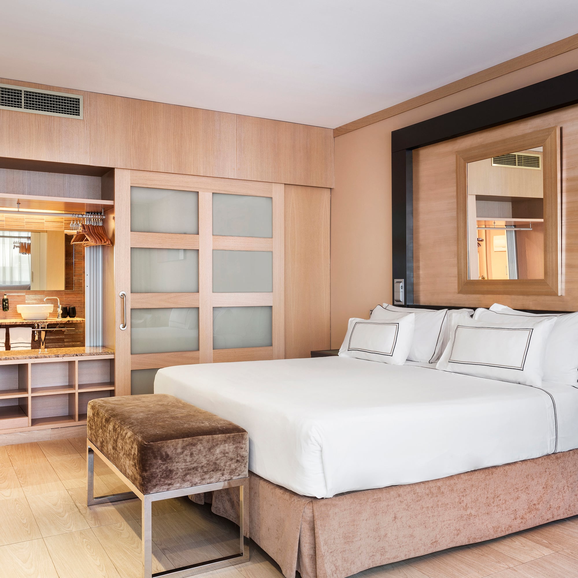 a bedroom with a bed and a mirror