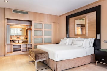 a bedroom with a bed and a mirror