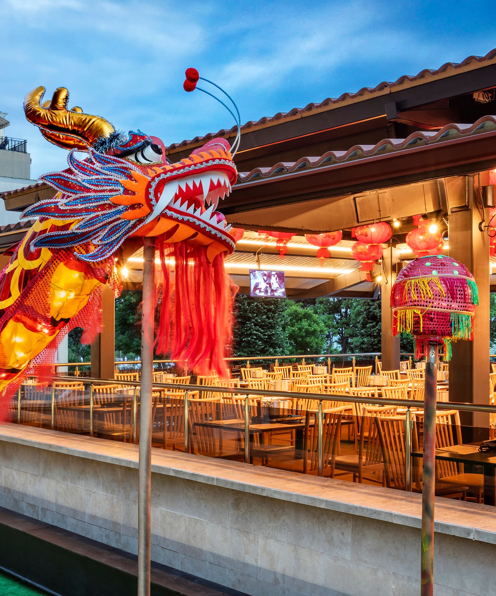 a large red and yellow dragon statue outside a restaurant
