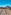 Gravel path to Teide volcano, clear blue sky over Tenerife volcanic landscape.