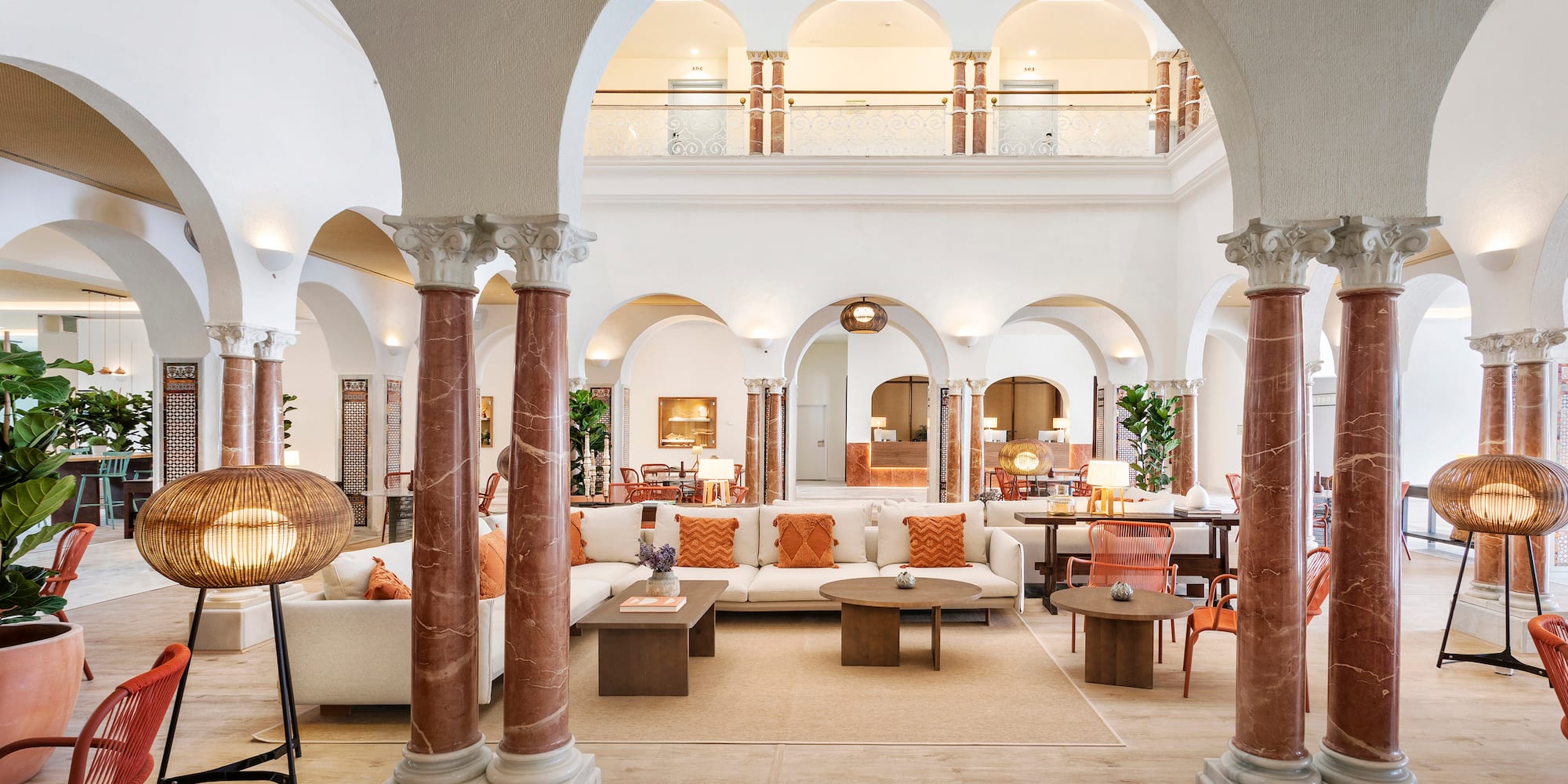a large white room with columns and a couch
