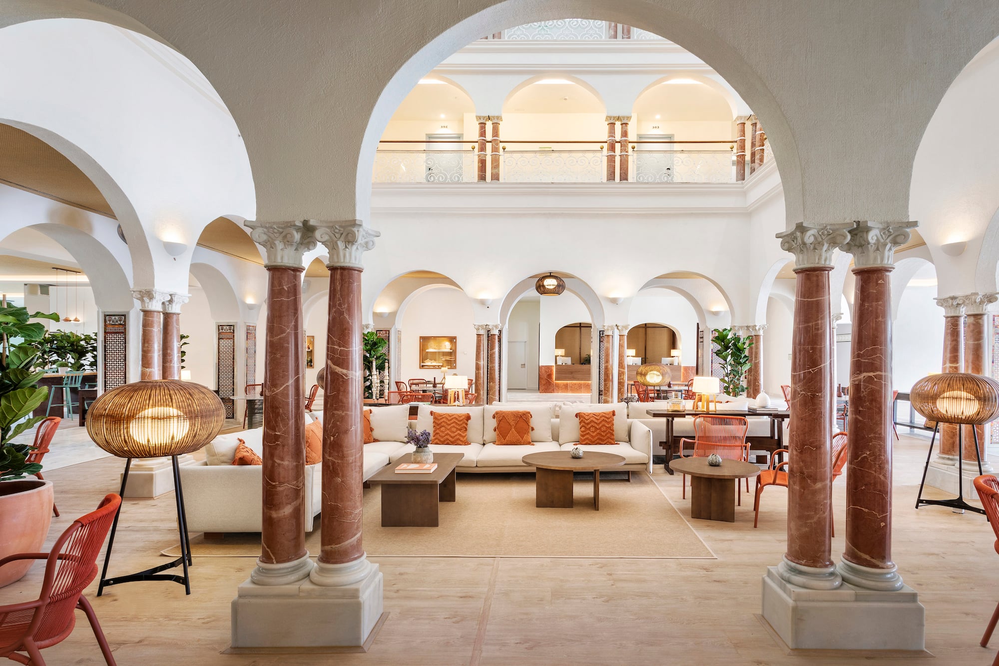 a large white room with columns and a couch