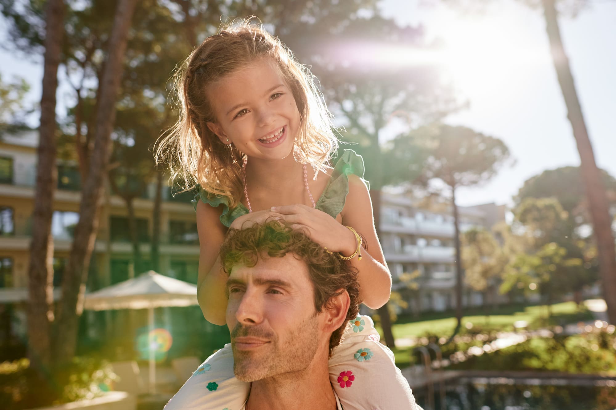 a girl sitting on a man's shoulders
