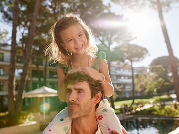 a girl sitting on a man's shoulders