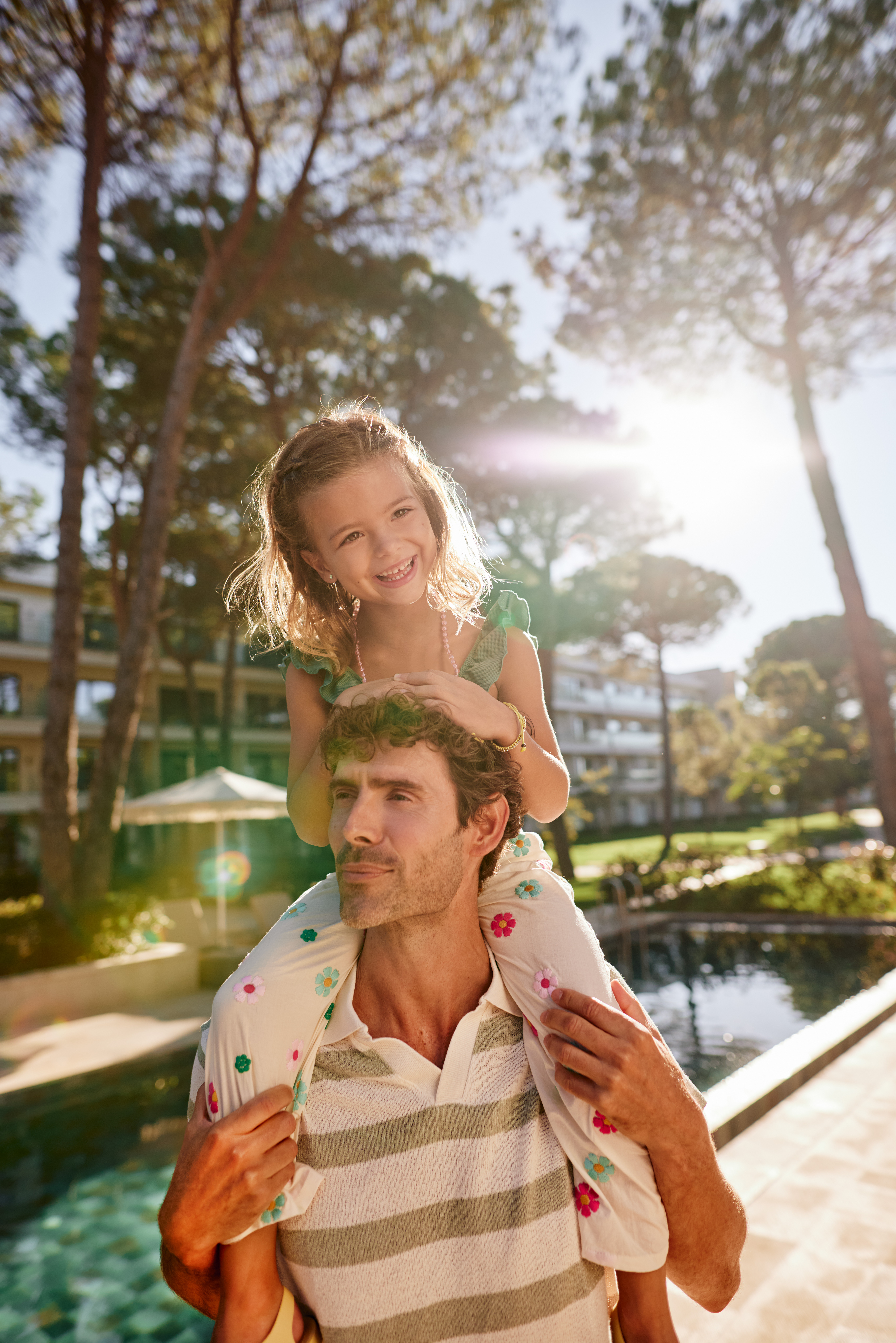 a girl sitting on a man's shoulders