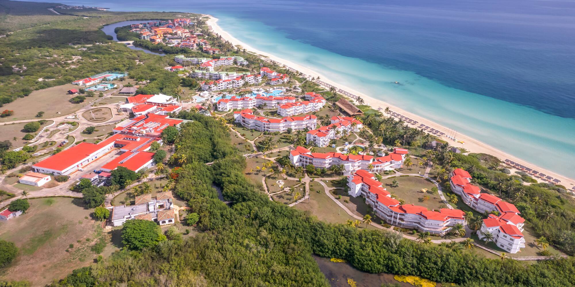 a aerial view of a beach with buildings and trees