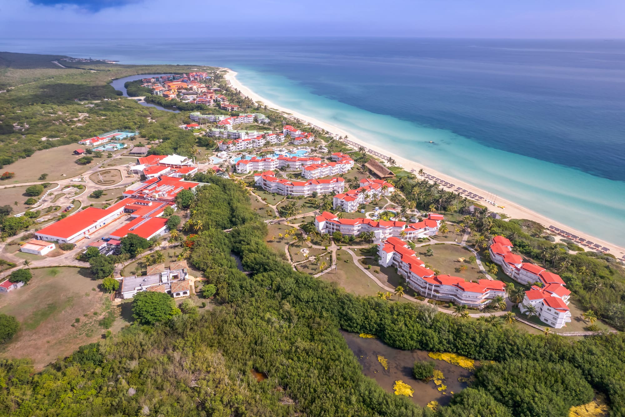 a aerial view of a beach with buildings and trees