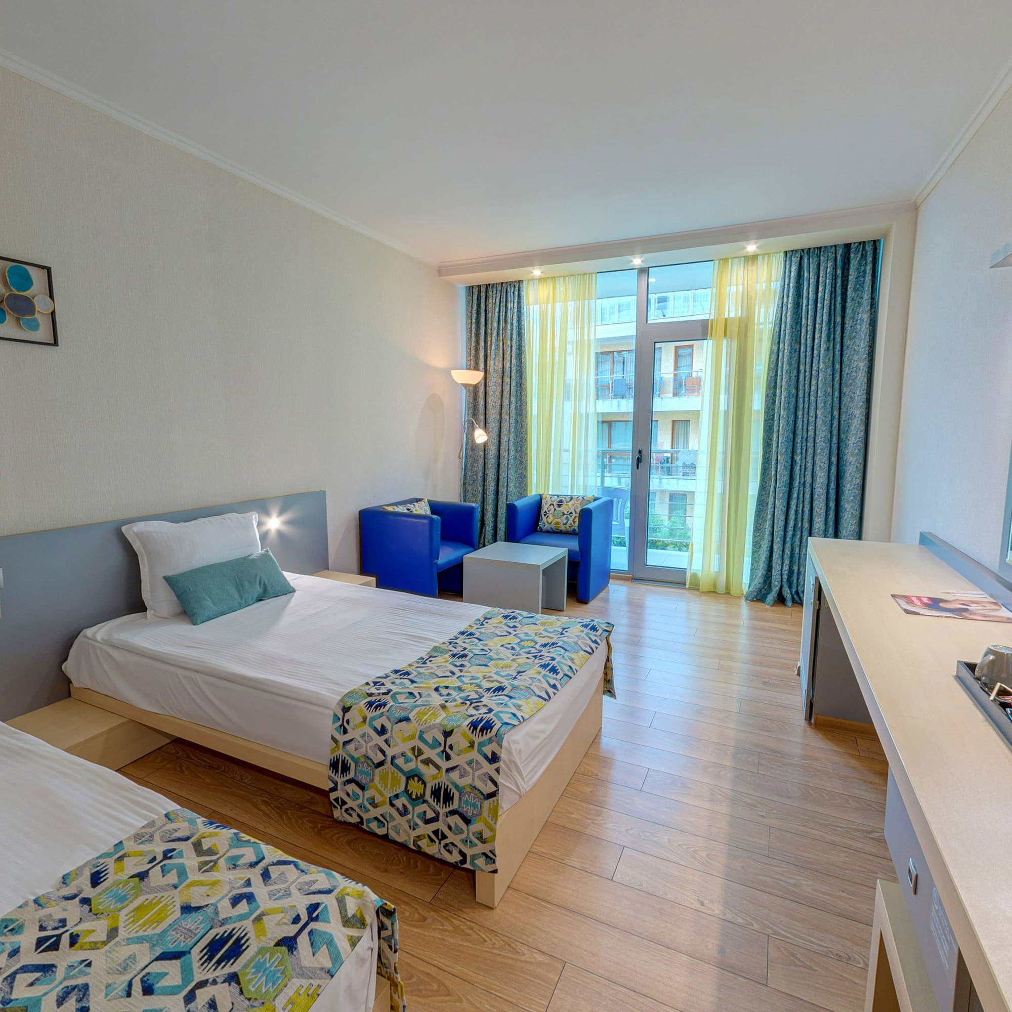 a room with two beds and a television