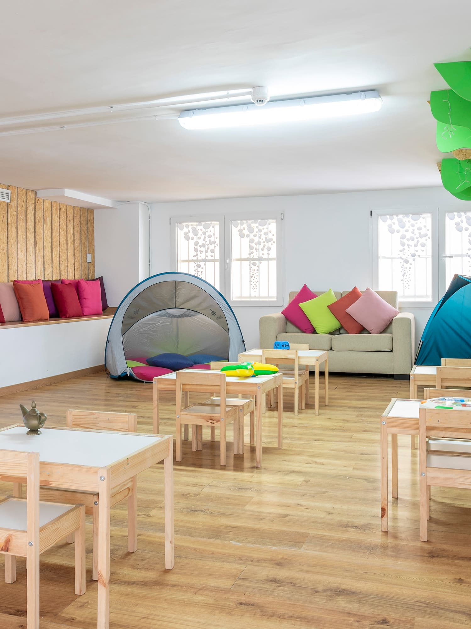 a room with tables and chairs and tents