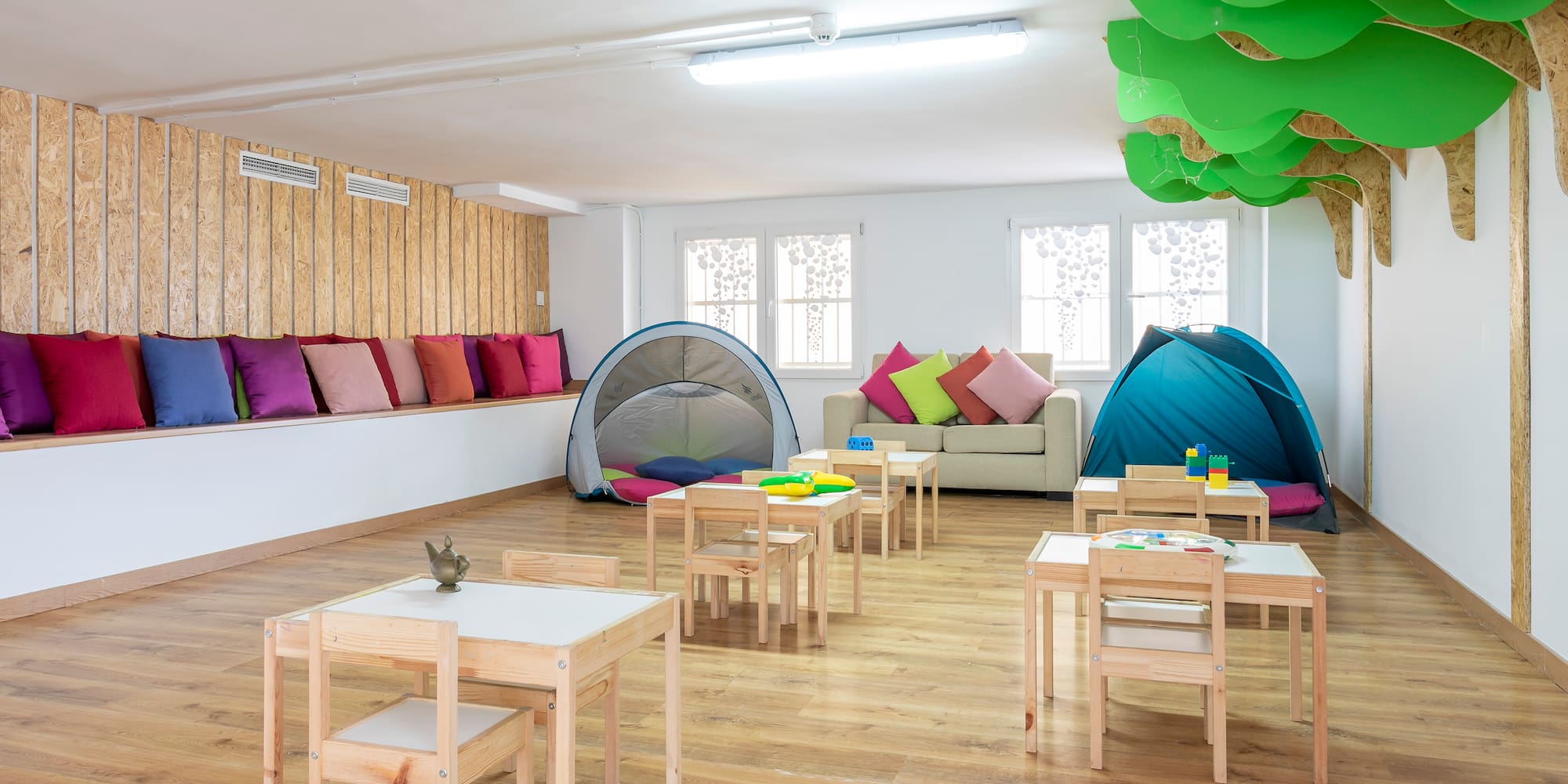 a room with tables and chairs and tents