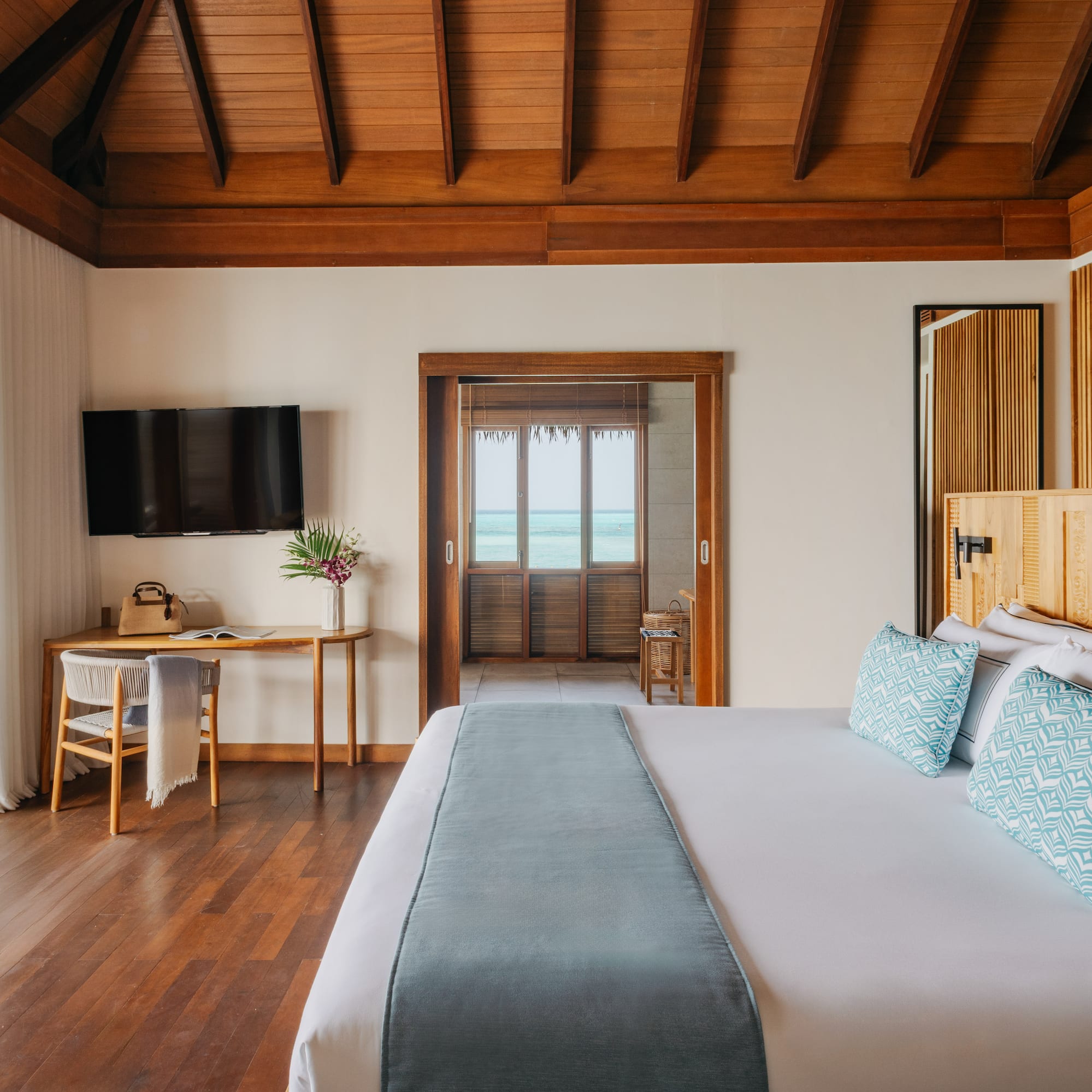 a bedroom with a large bed and a television