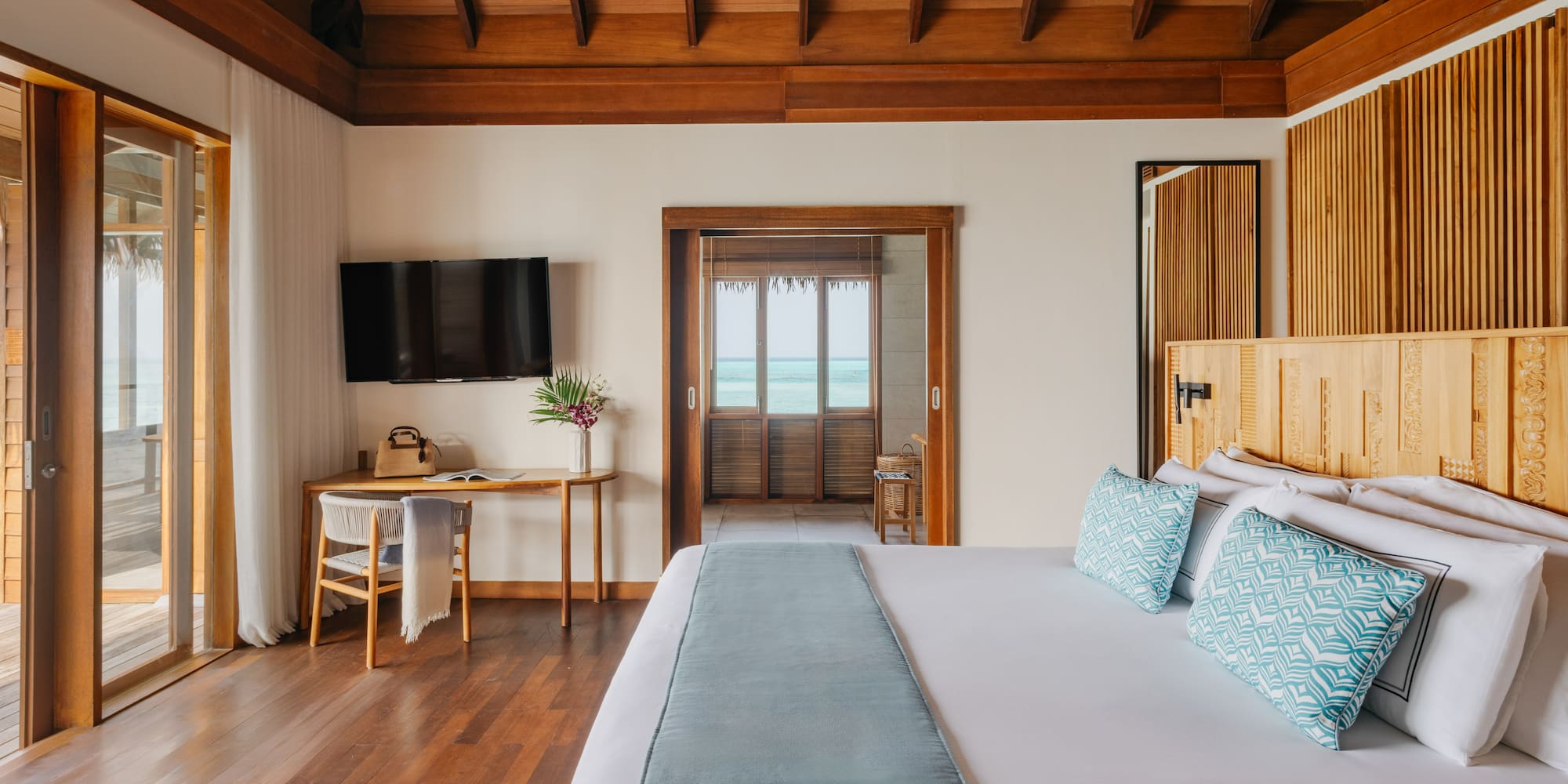 a bedroom with a large bed and a television