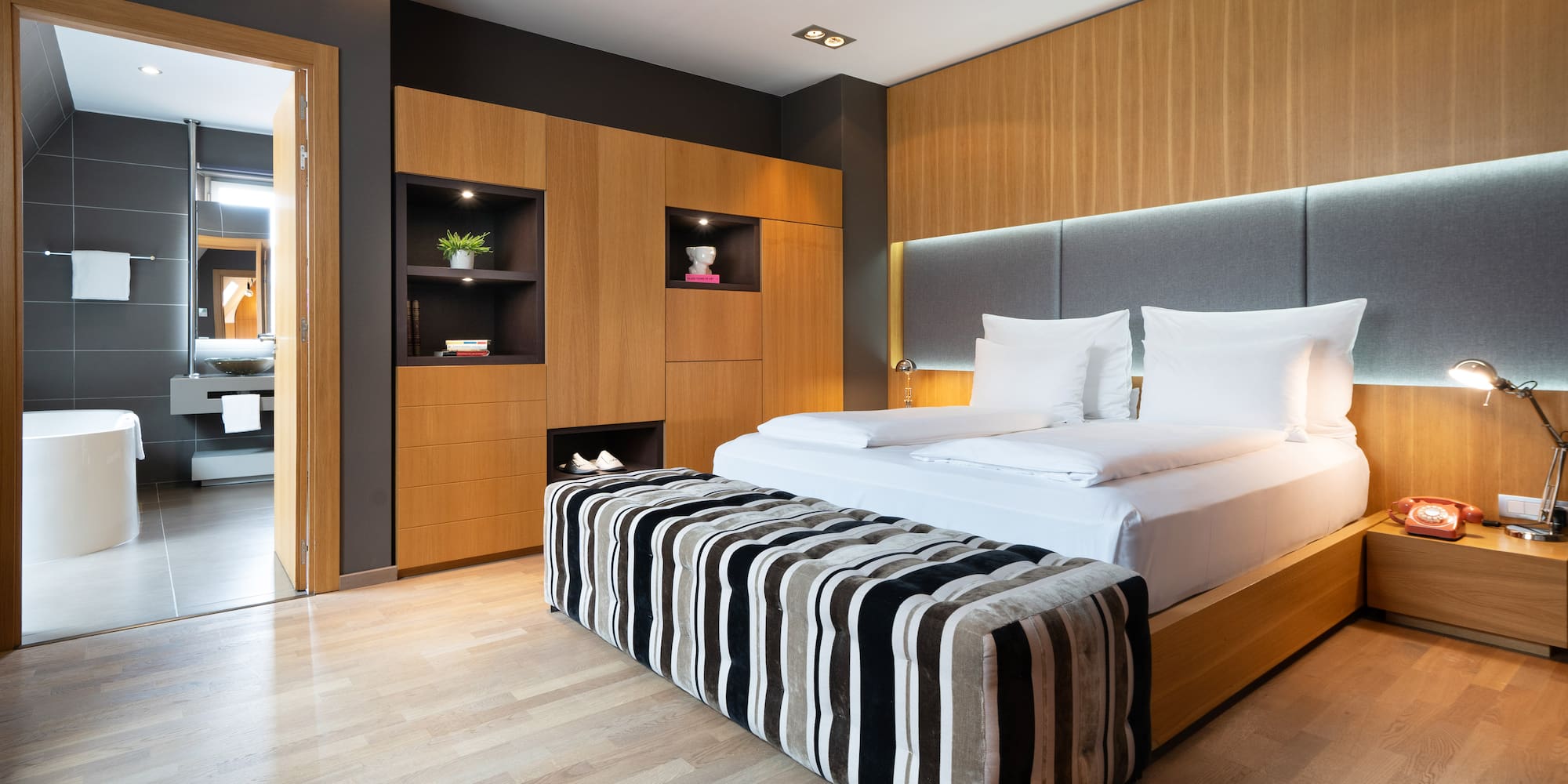 a room with a bed and a wood floor