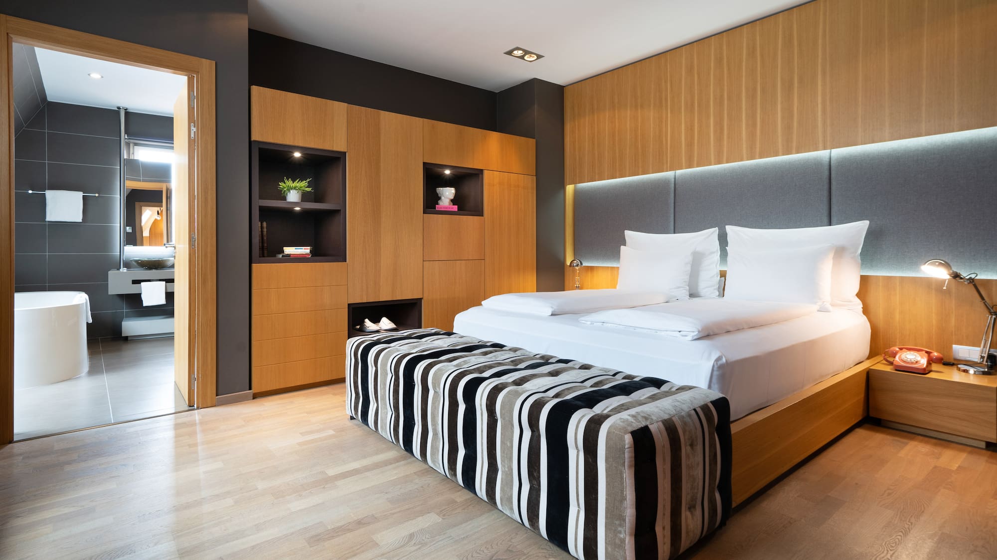 a room with a bed and a wood floor