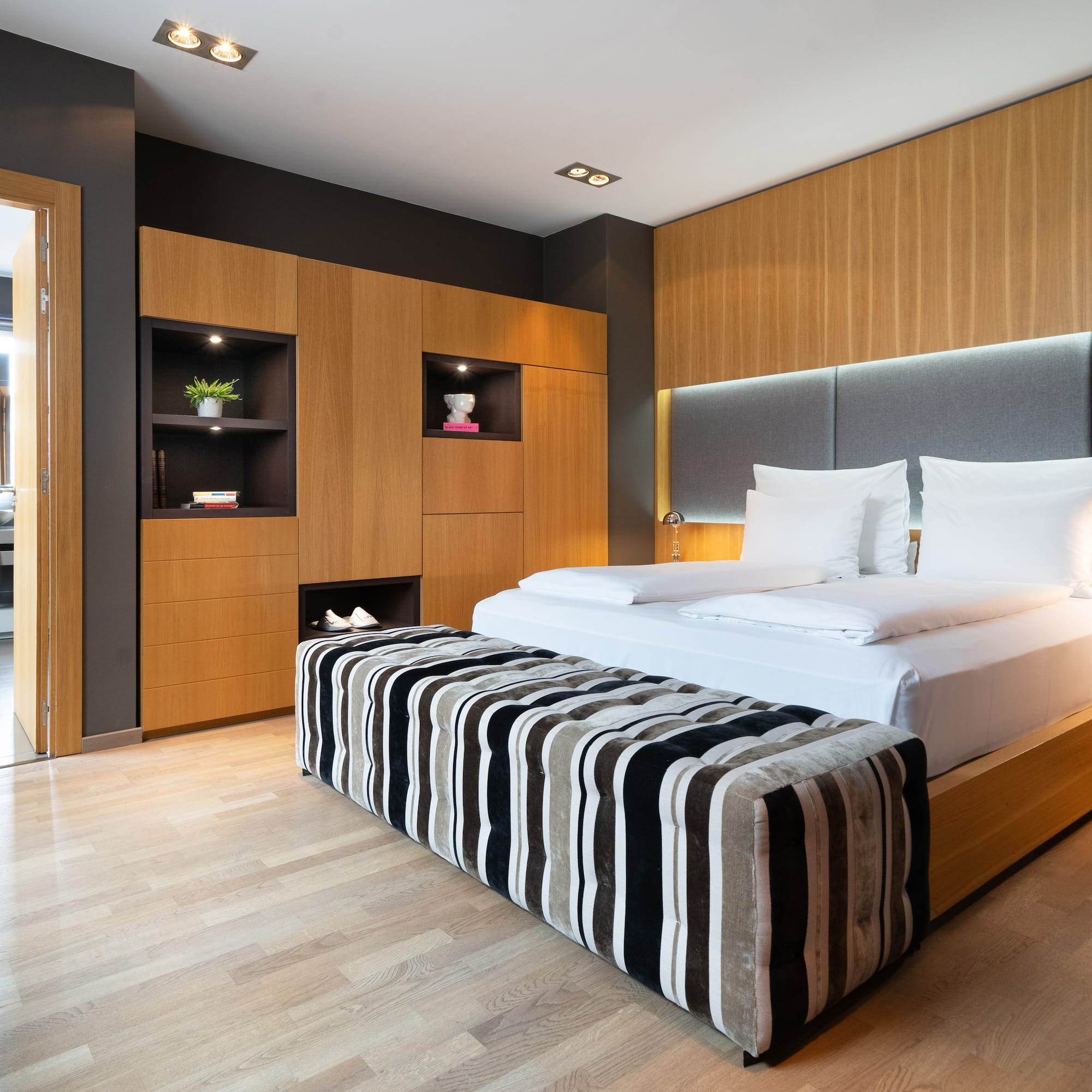 a room with a bed and a wood floor