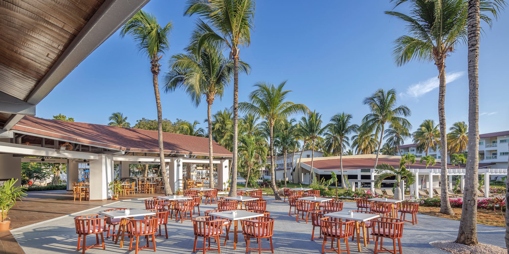 a group of tables and chairs outside of a building
