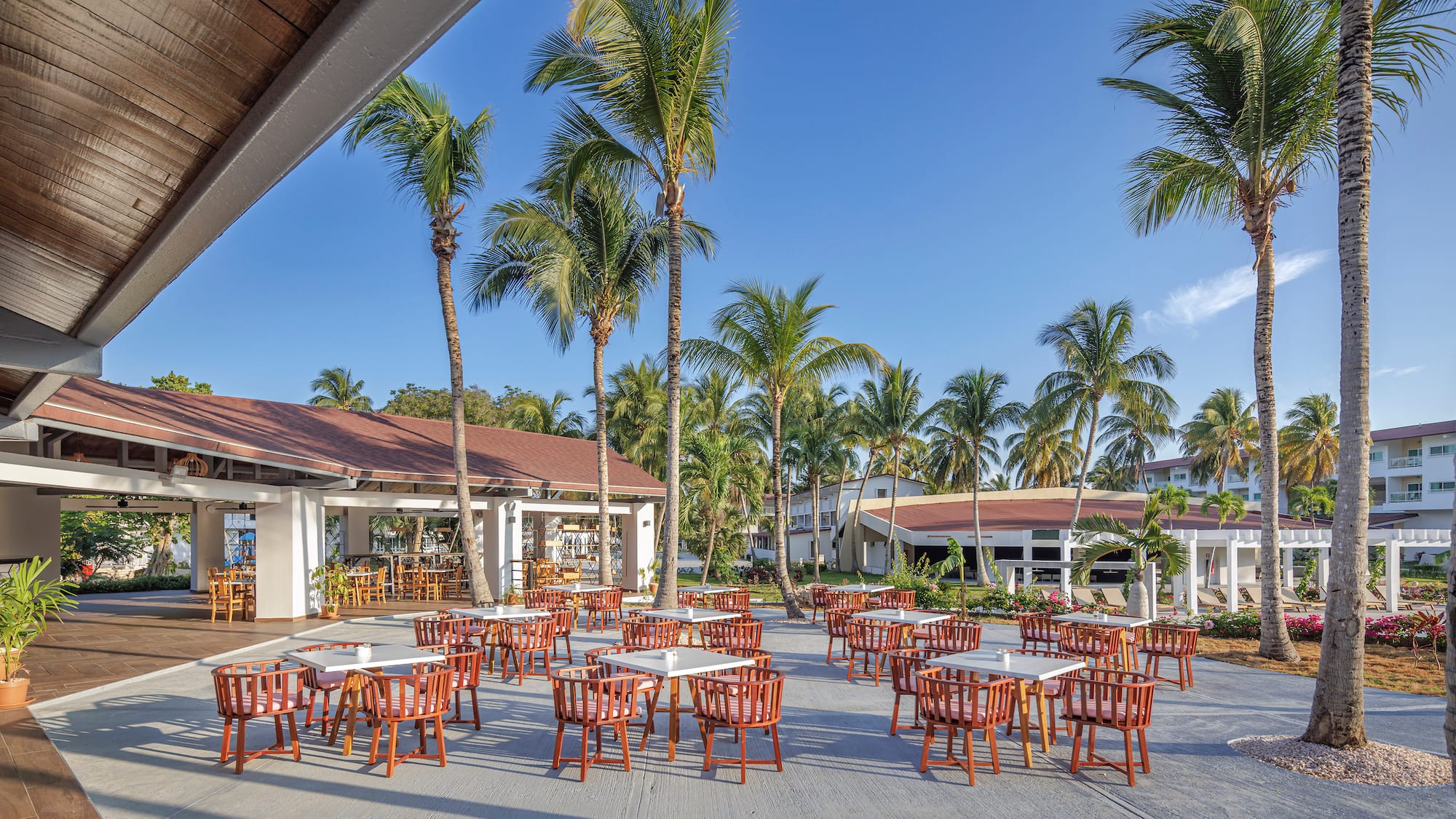 a group of tables and chairs outside of a building