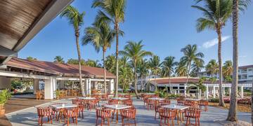 a group of tables and chairs outside of a building