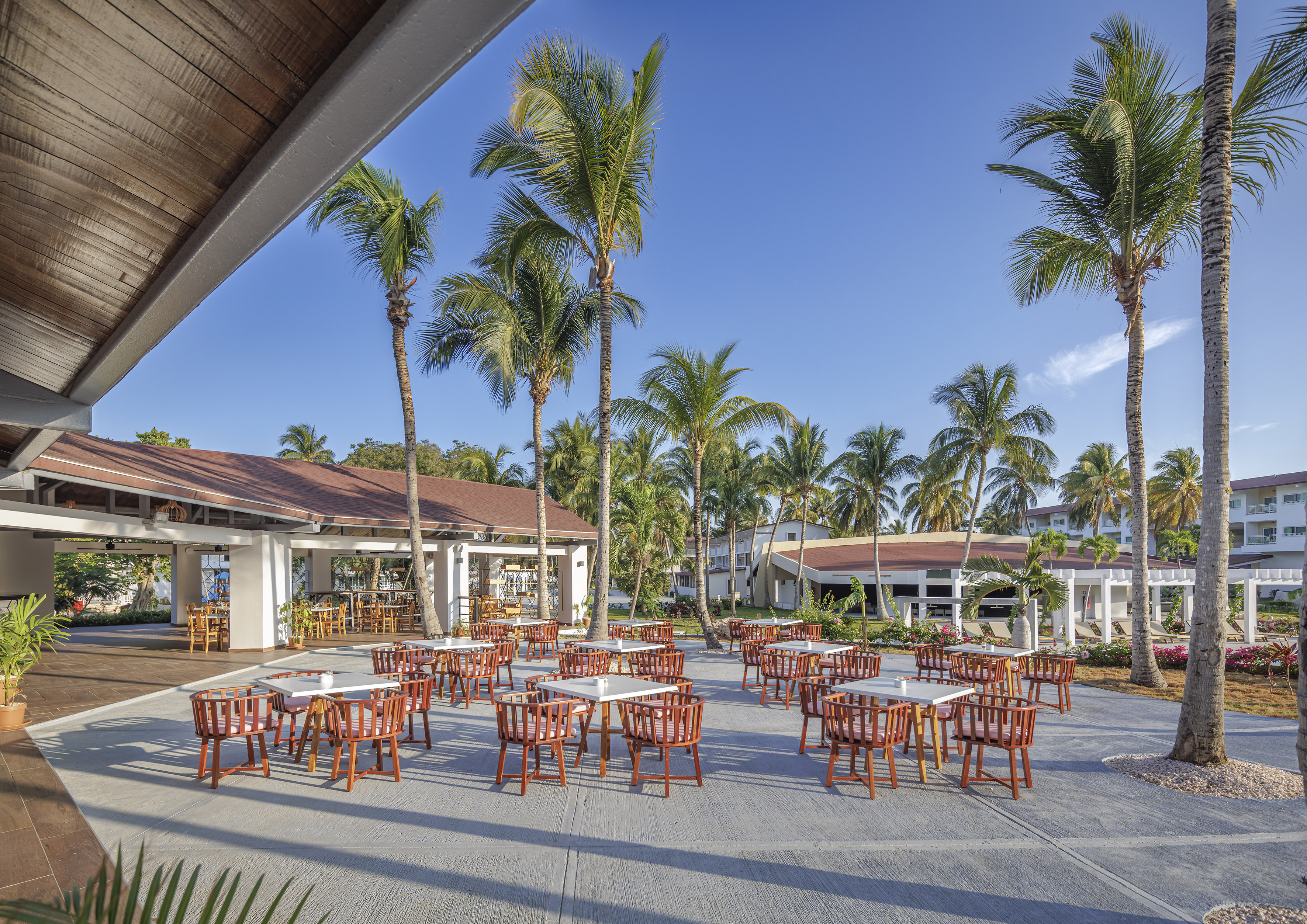 a group of tables and chairs outside of a building