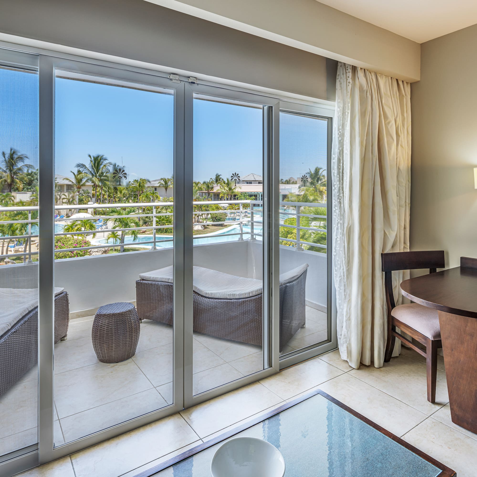 a room with a table and chairs and a glass door