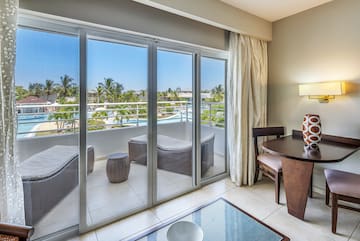 a room with a table and chairs and a glass door