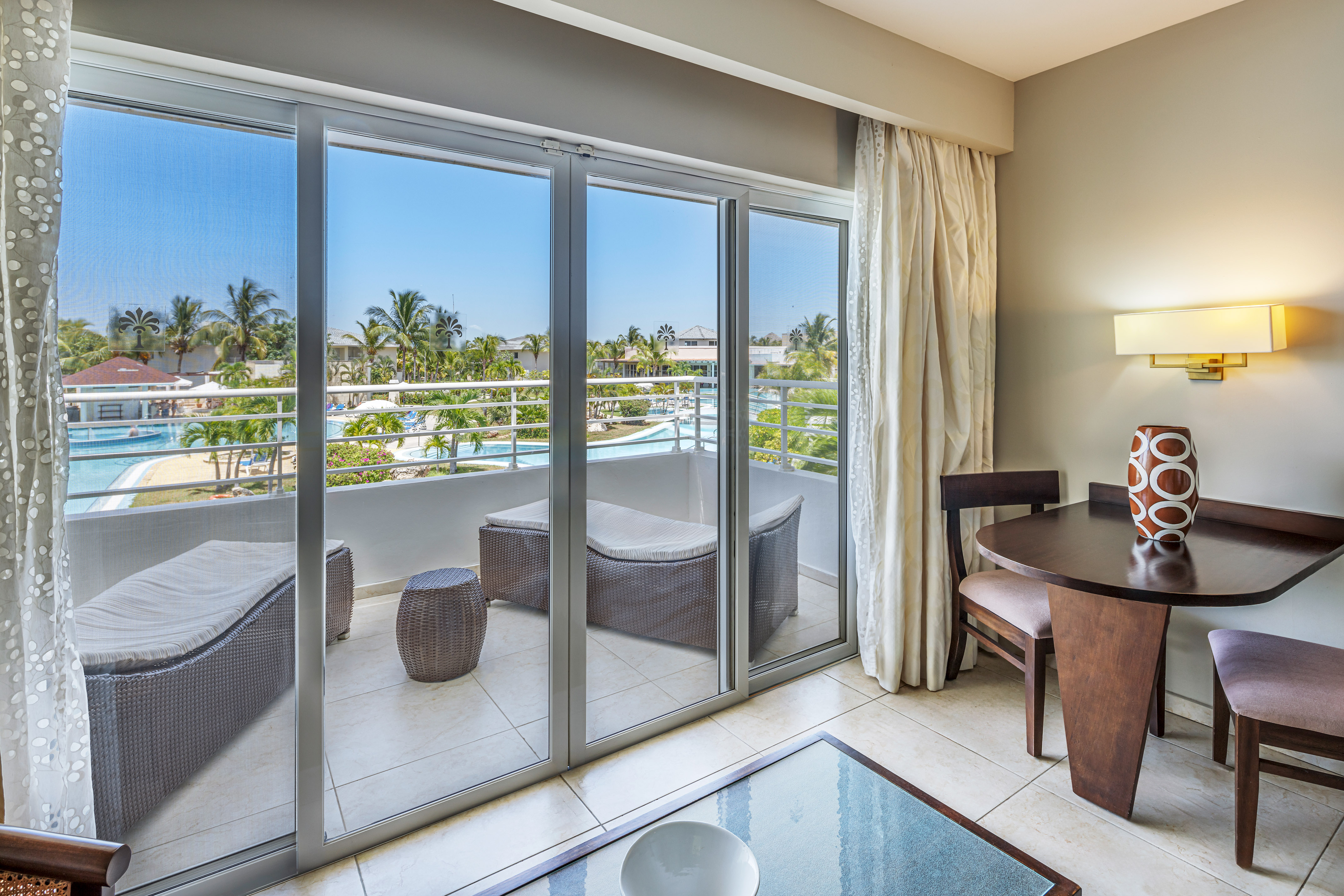 a room with a table and chairs and a glass door