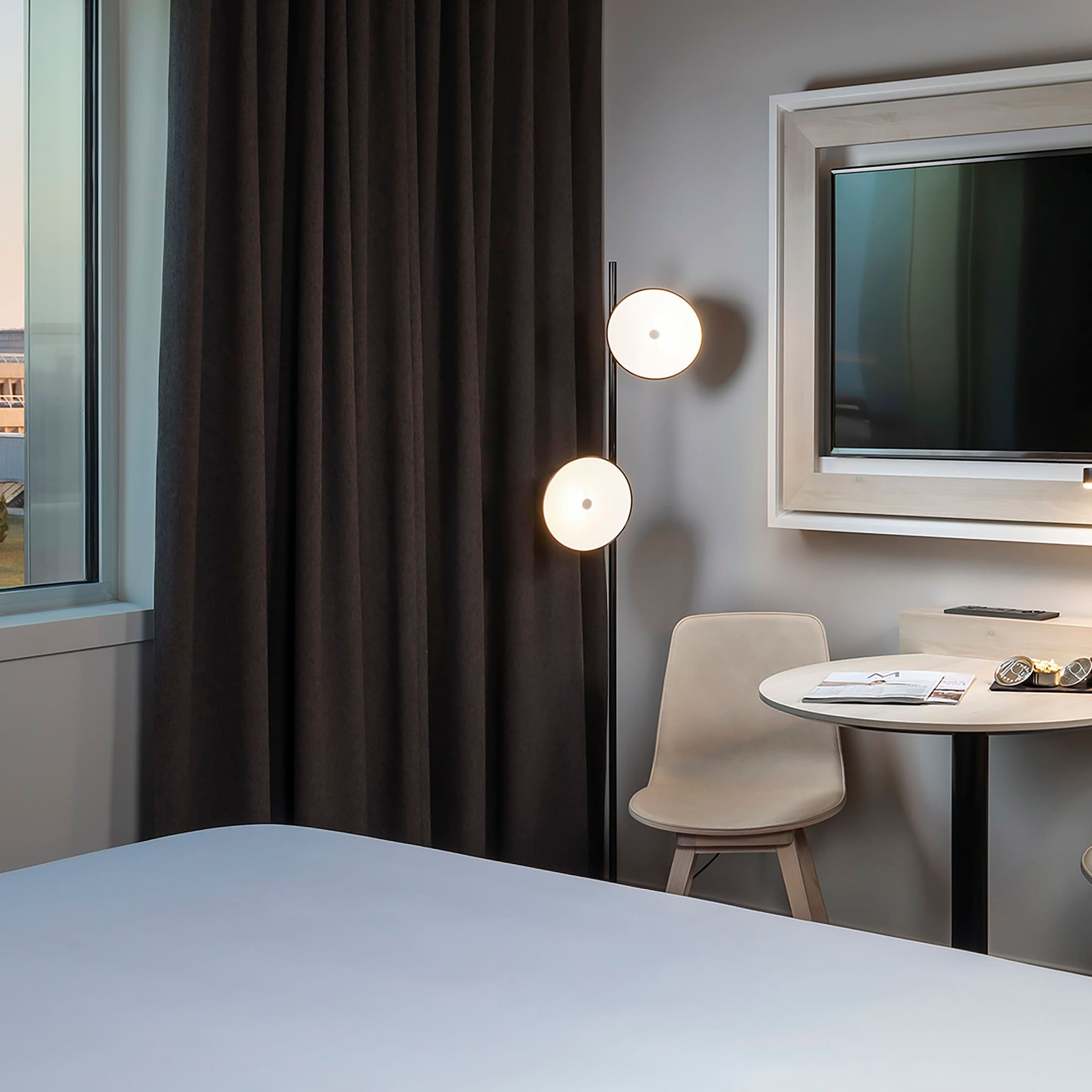 a room with a bed and a table and chairs