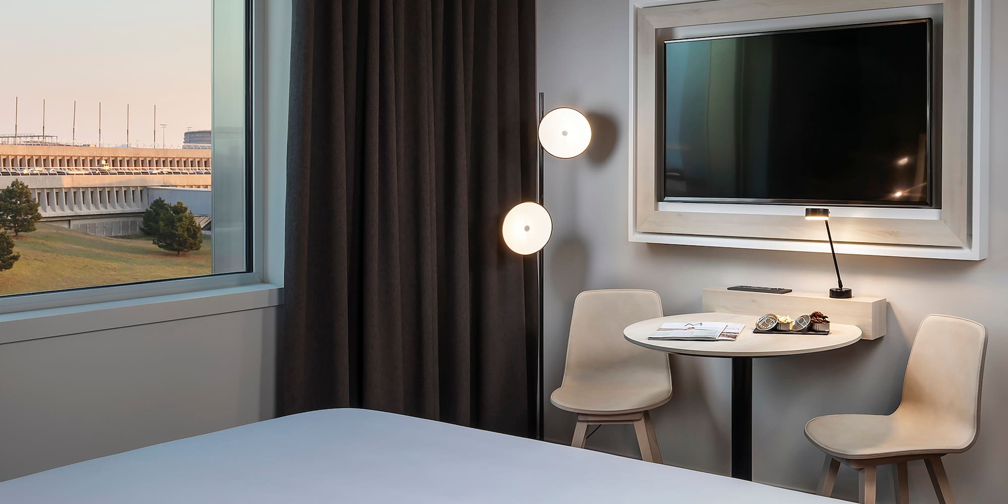 a room with a bed and a table and chairs