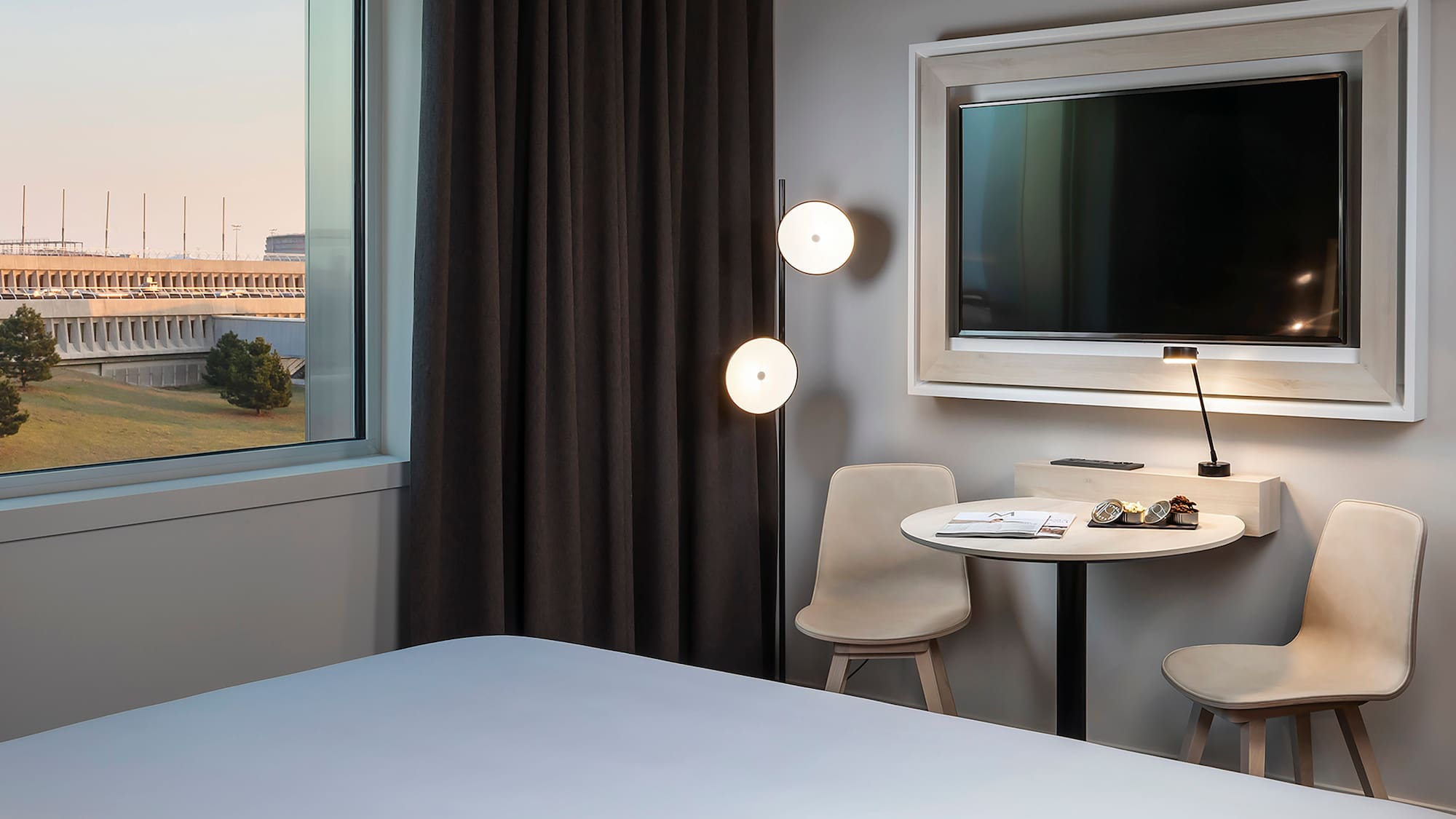 a room with a bed and a table and chairs