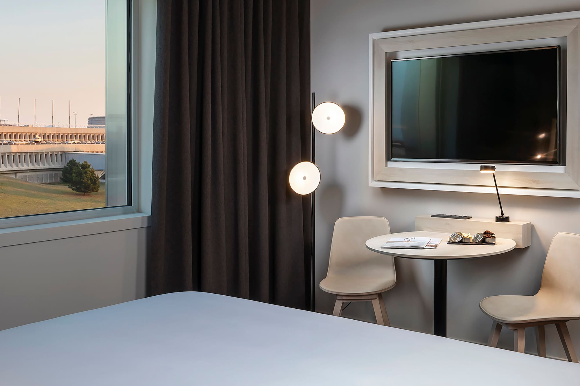 a room with a bed and a table and chairs