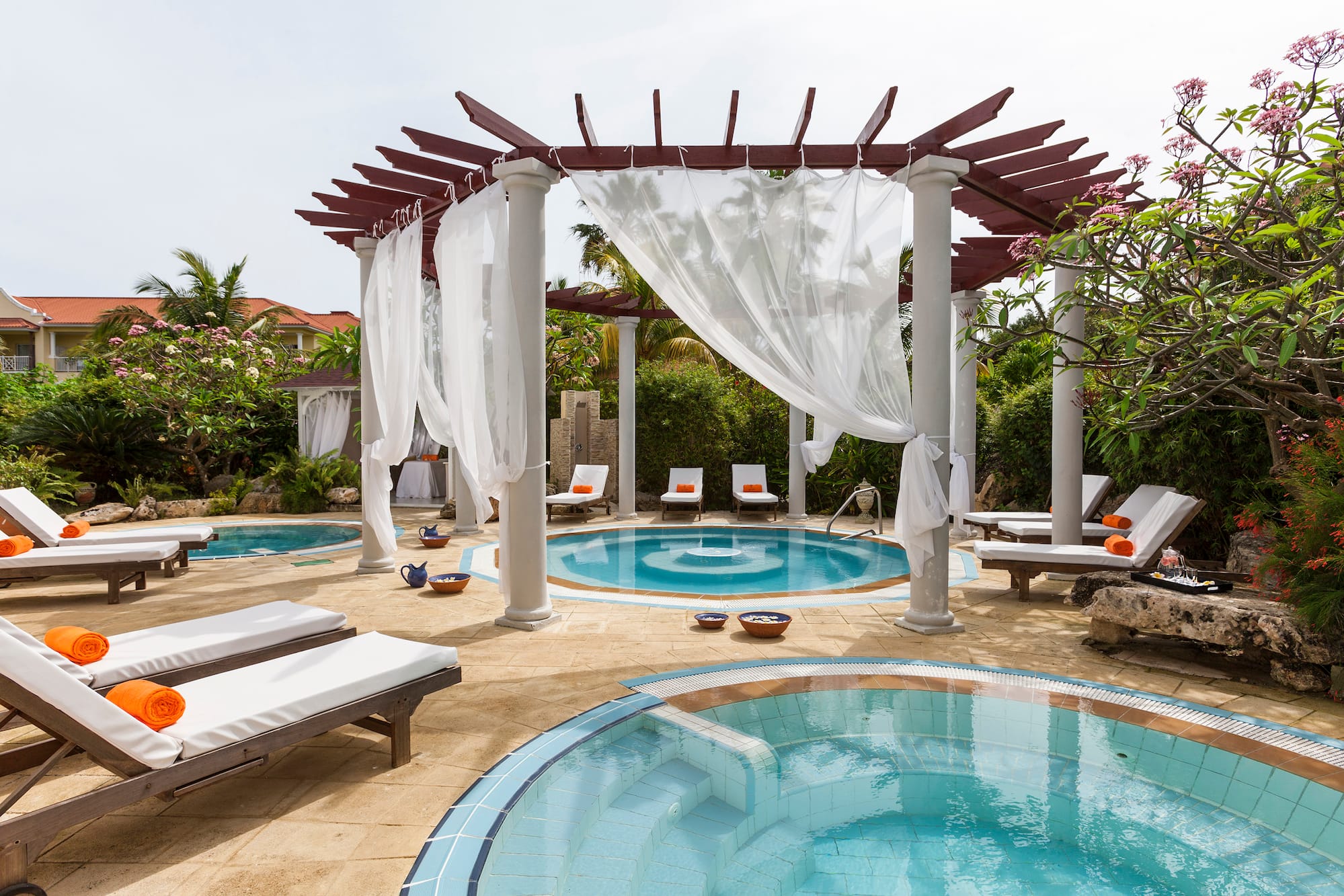 a pool with lounge chairs and a gazebo