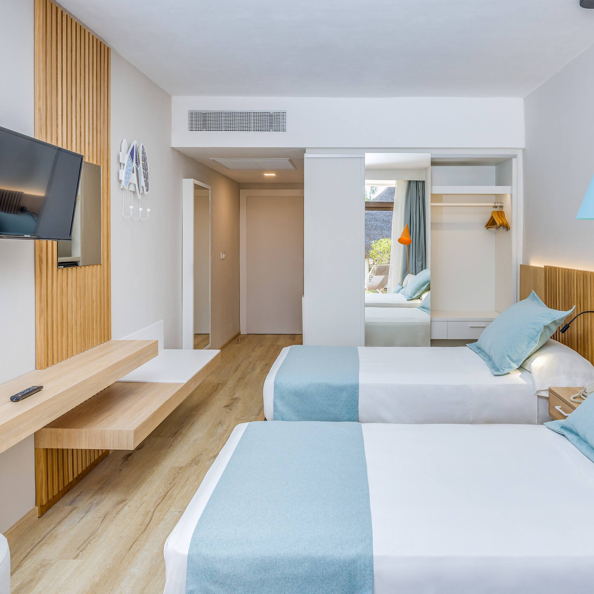 a room with two beds and a television