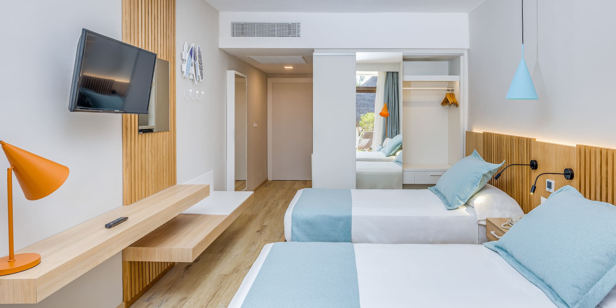 a room with two beds and a television