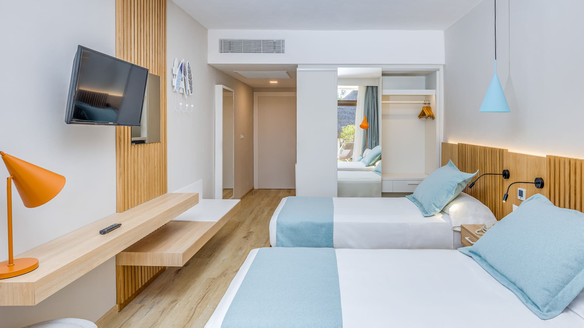 a room with two beds and a television