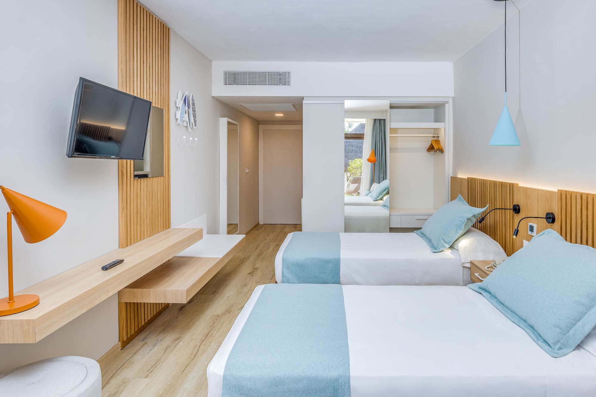 a room with two beds and a television