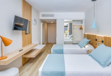 a room with two beds and a television