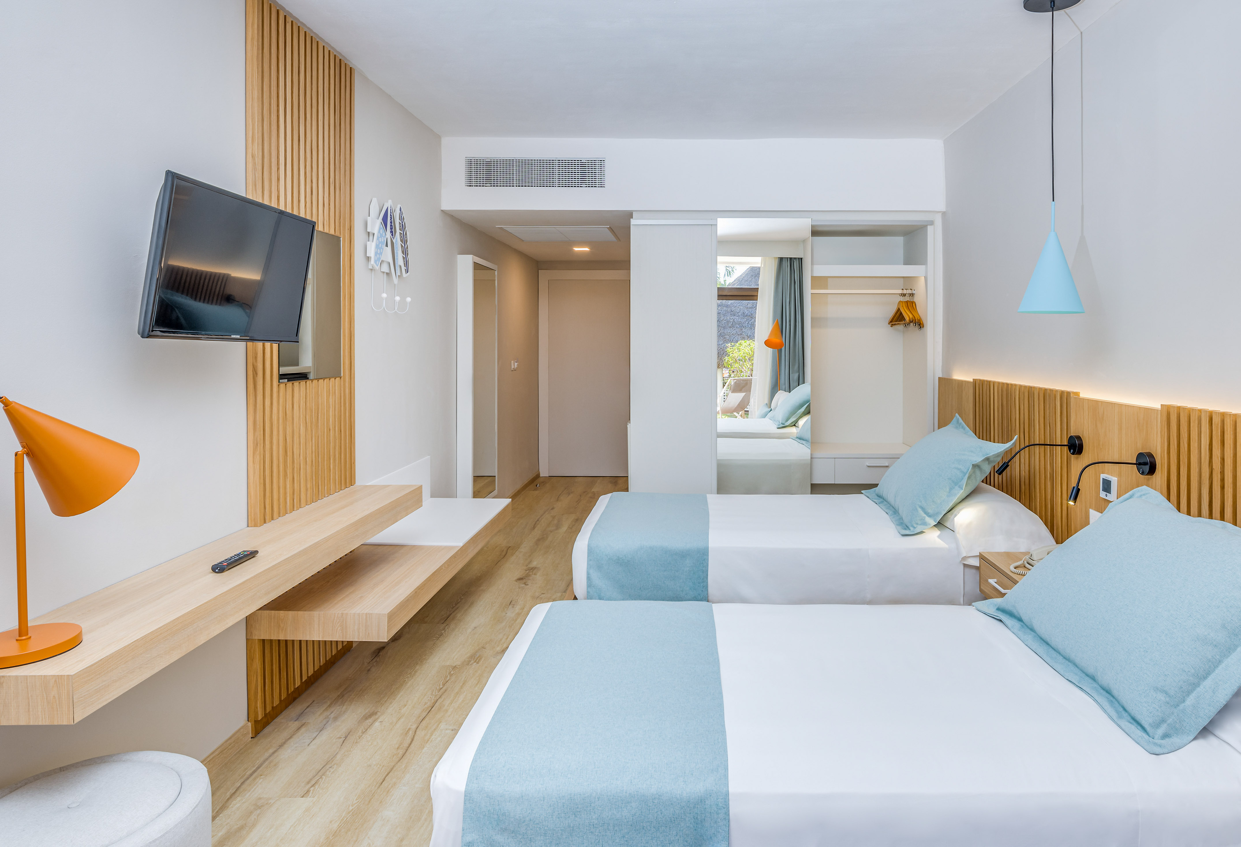 a room with two beds and a television