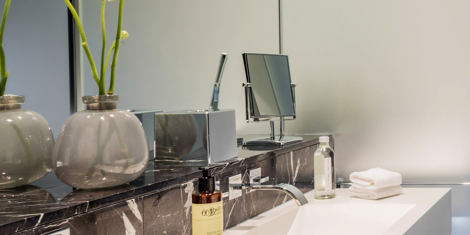 a bathroom with a marble counter top and white sink