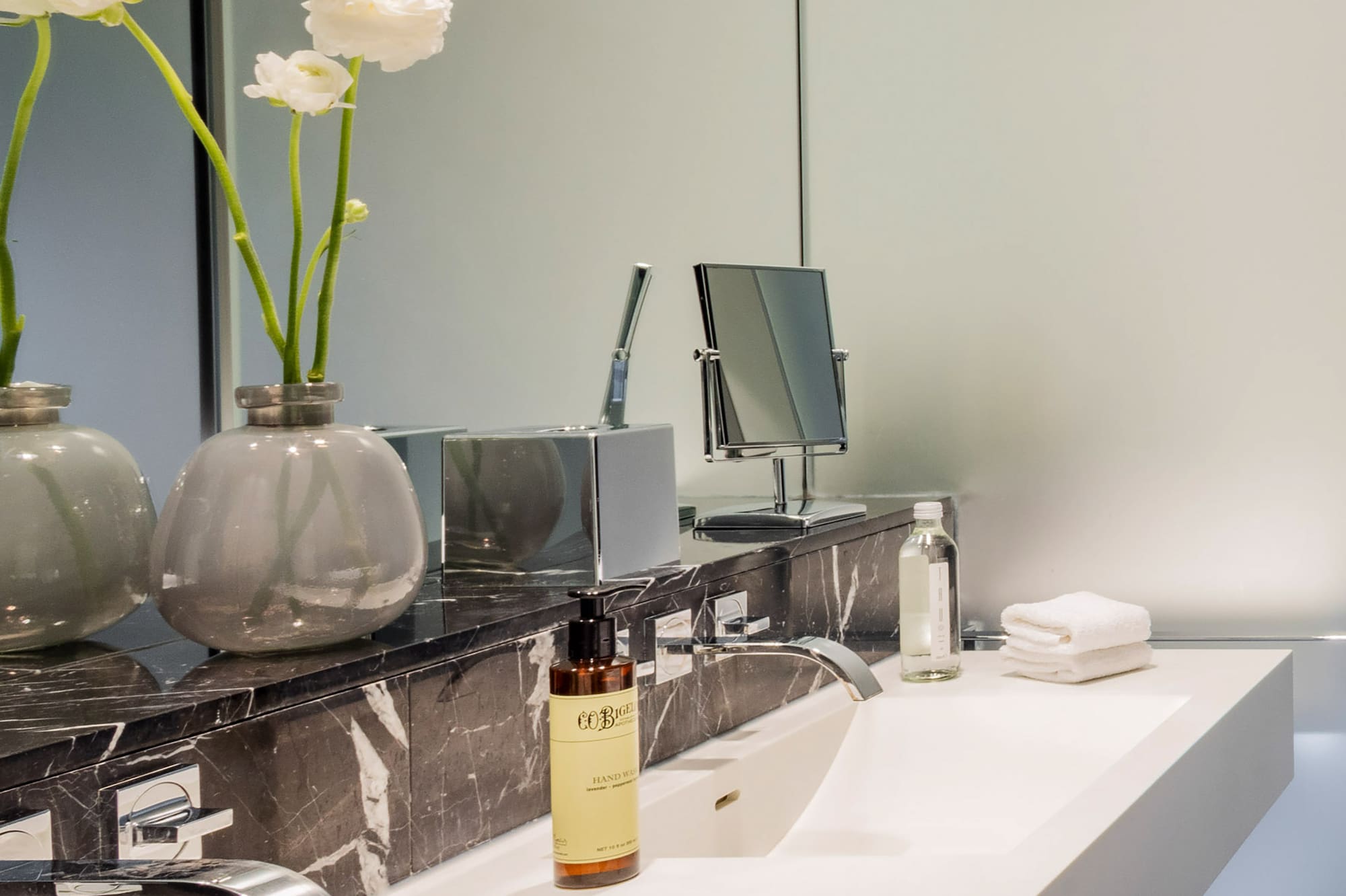 a bathroom with a marble counter top and white sink