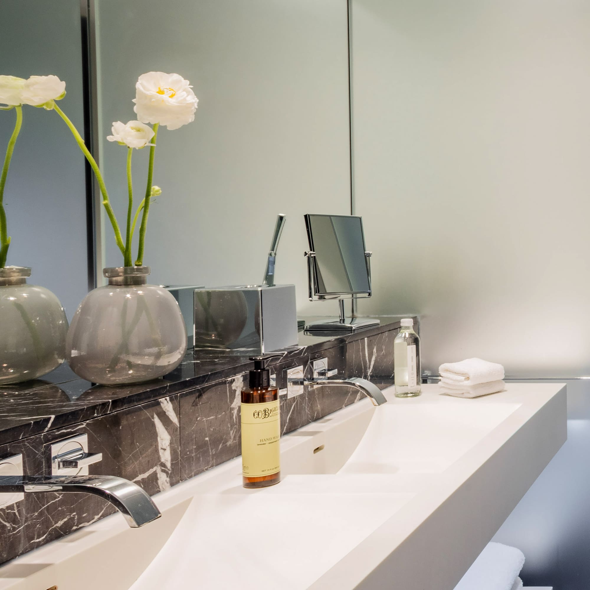 a bathroom with a marble counter top and white sink