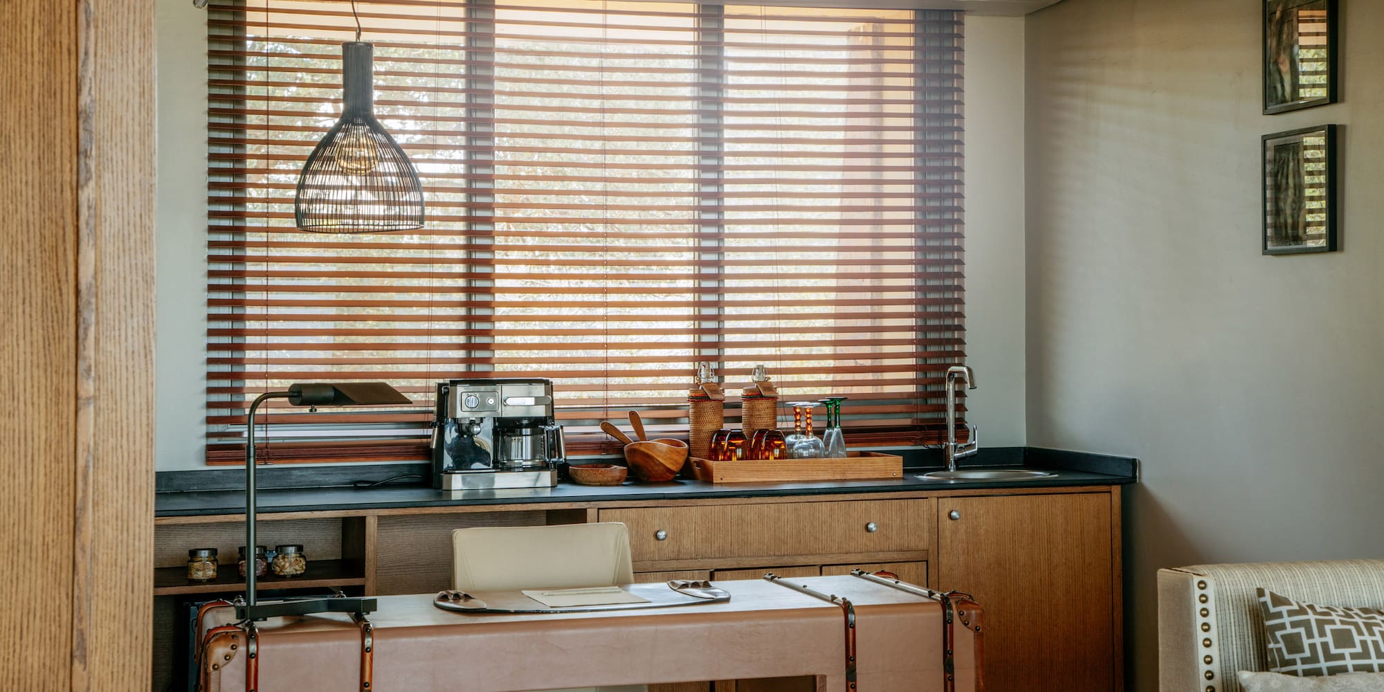 Home office and wet bar with coffee station, leather desk, wooden blinds.