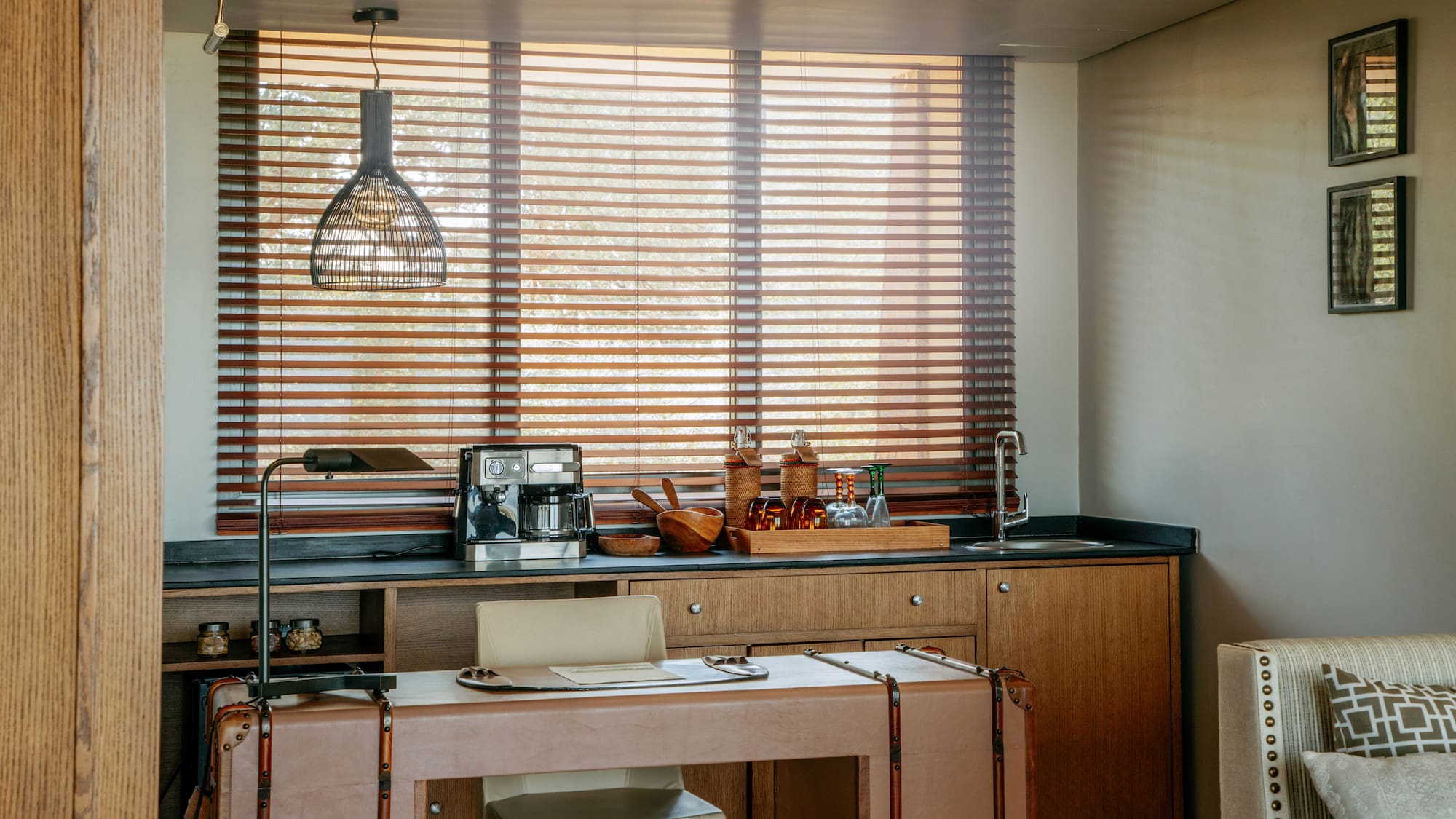 Home office and wet bar with coffee station, leather desk, wooden blinds.
